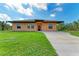 Single-story house with a light orange exterior and a brown roof at 397 Doniphan Dr, Port Charlotte, FL 33954