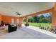 Covered patio with a seating area, overlooking a grassy backyard at 397 Doniphan Dr, Port Charlotte, FL 33954