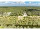 Aerial view of a house near a waterway, surrounded by green landscape at 397 Doniphan Dr, Port Charlotte, FL 33954