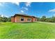 View of the side of the house with a lawn and trees at 397 Doniphan Dr, Port Charlotte, FL 33954