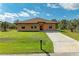 Single story house with a light orange exterior and a brown roof at 397 Doniphan Dr, Port Charlotte, FL 33954