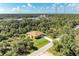 Aerial view of a single-story house with a brown roof and a large backyard at 397 Doniphan Dr, Port Charlotte, FL 33954