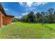 Large backyard with lush grass and tropical trees at 397 Doniphan Dr, Port Charlotte, FL 33954
