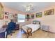 Bedroom with a queen-size bed, built-in desk, and multiple framed pictures at 397 Doniphan Dr, Port Charlotte, FL 33954