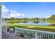 View of lake from backyard patio with white fence at 4832 Cobia Se Dr # B, St Petersburg, FL 33705