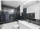 Modern bathroom with dark tile, white vanity, and updated fixtures at 4832 Cobia Se Dr # B, St Petersburg, FL 33705