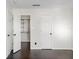Bright bedroom with dark wood floors, double door closet, and neutral walls at 4832 Cobia Se Dr # B, St Petersburg, FL 33705
