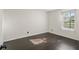 Spacious bedroom with dark hardwood floors and window at 4832 Cobia Se Dr # B, St Petersburg, FL 33705