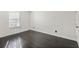 Spacious bedroom with dark hardwood floors and a window with blinds at 4832 Cobia Se Dr # B, St Petersburg, FL 33705