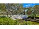 White footbridge over canal with tropical landscaping at 4832 Cobia Se Dr # B, St Petersburg, FL 33705