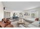 Bright living room featuring modern furnishings and an adjacent dining area with natural light at 4832 Cobia Se Dr # B, St Petersburg, FL 33705