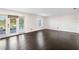 Bright living room with dark hardwood floors and access to patio at 4832 Cobia Se Dr # B, St Petersburg, FL 33705