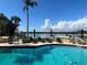 The outdoor pool area has waterfront views, lounge chairs, and umbrellas at 5701 Mariner St # 502, Tampa, FL 33609