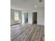 Bright and spacious main bedroom with wood-look floors and access to bathroom at 5714 Olive Dr, New Port Richey, FL 34652