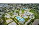 Aerial view showcasing community recreation center with pools, tennis courts, and parking at 5714 Olive Dr, New Port Richey, FL 34652
