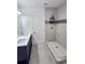 Updated bathroom with double vanity, walk-in shower, and stylish tile at 5714 Olive Dr, New Port Richey, FL 34652