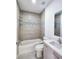 Clean bathroom with bathtub, toilet, and modern vanity at 5714 Olive Dr, New Port Richey, FL 34652