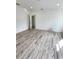 Well lit bedroom with wood-look floors and ample closet space at 5714 Olive Dr, New Port Richey, FL 34652