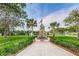 Scenic park view featuring the Veterans Memorial, walkways, lush green lawns, and tropical palm trees at 5714 Olive Dr, New Port Richey, FL 34652