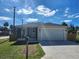 Newly built home with modern exterior, attached garage, and a spacious front yard at 5714 Olive Dr, New Port Richey, FL 34652