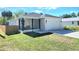 Charming single-Gathering home features a well-maintained lawn, inviting front porch, and convenient attached garage at 5714 Olive Dr, New Port Richey, FL 34652