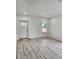 Bright and airy living room featuring wood-look flooring and ample natural light at 5714 Olive Dr, New Port Richey, FL 34652