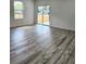 Spacious living room with sliding glass doors leading to a private backyard at 5714 Olive Dr, New Port Richey, FL 34652