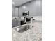 Modern kitchen featuring stainless steel appliances and granite countertops at 5714 Olive Dr, New Port Richey, FL 34652