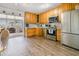 Kitchen with light wood cabinets, stainless steel appliances, and vinyl flooring at 708 Rutgers Pl, Sun City Center, FL 33573