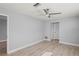 Bright bedroom with ceiling fan and wood-look floors at 8312 Roxboro Dr, Hudson, FL 34667