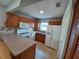 Galley kitchen with wood cabinets and white appliances at 5705 103Rd N Ter, Pinellas Park, FL 33782