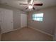 Well-lit bedroom with ceiling fan and double closets at 5705 103Rd N Ter, Pinellas Park, FL 33782