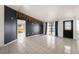 Bright living room with tiled floors and dark accent wall at 9102 Post Oak Ct, Tampa, FL 33615