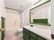 Clean bathroom with green vanity and shower/tub combo at 9102 Post Oak Ct, Tampa, FL 33615
