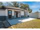 Front view of house with gray and white siding at 9102 Post Oak Ct, Tampa, FL 33615
