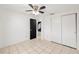 Bedroom with tiled floors, ceiling fan, and double door closet at 9102 Post Oak Ct, Tampa, FL 33615