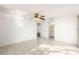 Bedroom with tiled floors, ceiling fan, and access to bathroom at 9102 Post Oak Ct, Tampa, FL 33615
