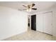 Bedroom with tiled floors, ceiling fan, and access to bathroom at 9102 Post Oak Ct, Tampa, FL 33615