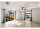 Bedroom with tiled floors, sliding glass doors to backyard, and ceiling fan at 9102 Post Oak Ct, Tampa, FL 33615