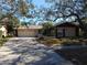 Single-story house with attached two-car garage and driveway at 1291 S Disston Ave, Tarpon Springs, FL 34689