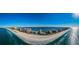 Sweeping aerial view of the shoreline, beautiful buildings, and crystal clear water at 1390 Gulf Blvd # 1204, Clearwater, FL 33767