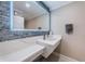 Modern bathroom with stylish mirror, floating vanity, and beautiful tile backsplash at 1390 Gulf Blvd # 1204, Clearwater, FL 33767