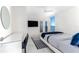 Bedroom with bay view, white dresser, and blue bedding at 1390 Gulf Blvd # 1204, Clearwater, FL 33767