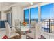 Glass dining table with four chairs, ocean view at 1390 Gulf Blvd # 1204, Clearwater, FL 33767