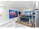 Open concept dining area with a glass table and modern art at 1390 Gulf Blvd # 1204, Clearwater, FL 33767