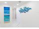 Bright hallway with marble floors and modern wall art at 1390 Gulf Blvd # 1204, Clearwater, FL 33767