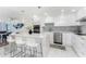 Modern white kitchen with stainless steel appliances and a large island at 1390 Gulf Blvd # 1204, Clearwater, FL 33767
