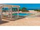 Beautiful community pool featuring trellis, sunshade and plenty of seating at 1390 Gulf Blvd # 1204, Clearwater, FL 33767