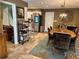 Open-concept dining room with stainless steel appliances, kitchen island, and chandelier at 14492 Tanglewood N Dr, Largo, FL 33774