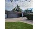 Exterior shot of home with driveway, garage, and well-manicured lawn at 14492 Tanglewood N Dr, Largo, FL 33774